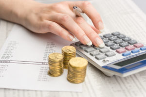 Image of a budget, coins and calculator