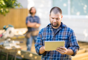 Image of a builder going over the plans