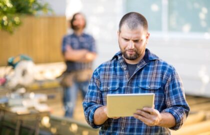 Image of a builder going over the plans