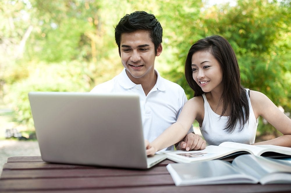 A couple looking at their computer together