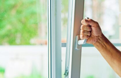 Image of a man opening an unsecured window